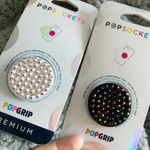 Two rhinestone phone grips in their packaging