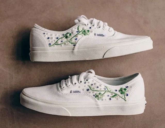 White sneakers with green vine embroidery and crystals