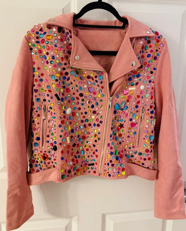 Pink leather jacket covered in multicolor gemstones
