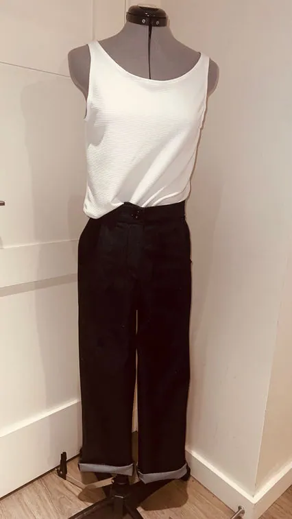 White tank and black trousers on a dress form
