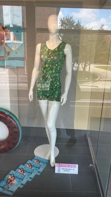Green floral romper in a display case