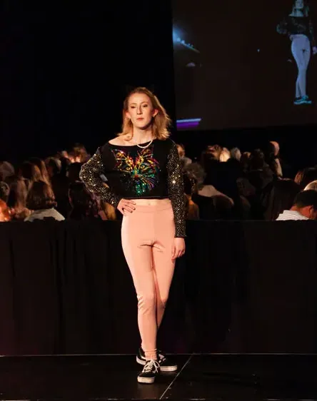 Black top and pale pink trousers, front