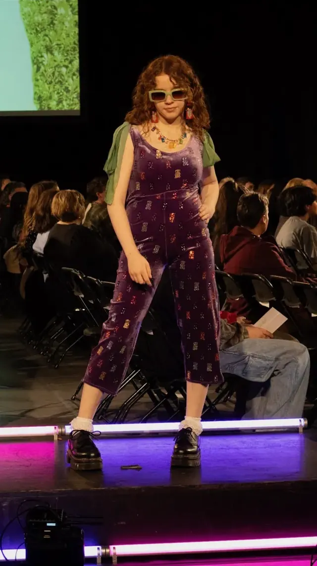 Model in a purple stretch-velvet jumpsuit on the runway