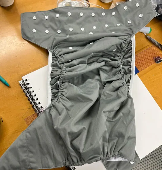 Grey cloth diaper prototype with snaps